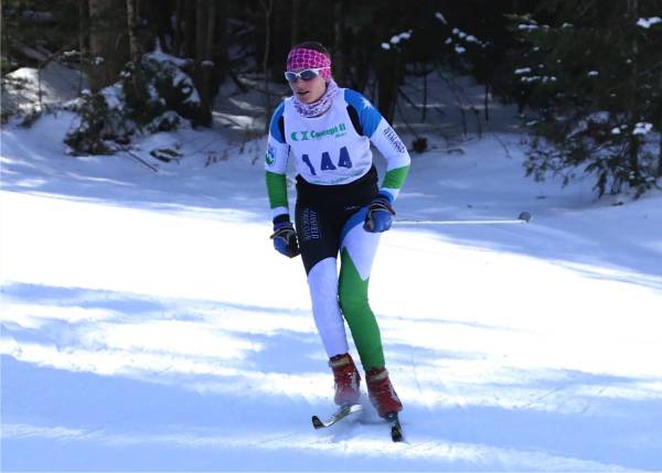 Eliza skiing fast and rounding the corner